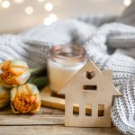 Cozy home composition for Autumn with a candlestick, decor element and flowers.