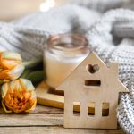 Cozy home composition for Autumn with a candlestick, decor element and flowers.