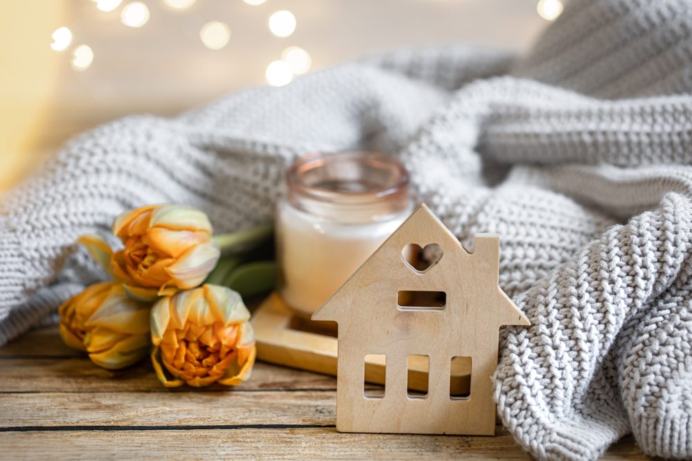 Cozy home composition for Autumn with a candlestick, decor element and flowers.